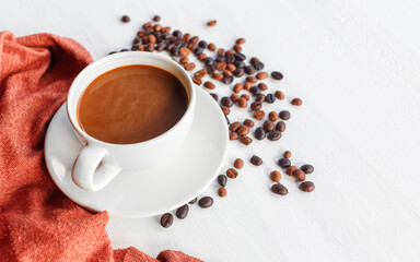 coffee cup and coffee beans on white wooden background