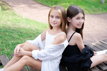 sisterhood. two sisters or friends spending time outdoors on sunny summer day. bff, sibling,...