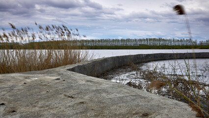 Old soviet river dam in spring