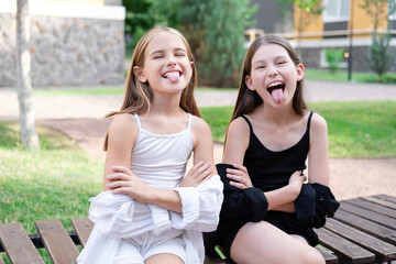 happy and lucky to have a sister. two girls outdoors in black and white clothes. good and bad....