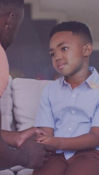 Animation Of Lights Over African American Father And Son Having Serious Conversation