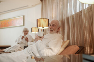 A senior couple having a peaceful morning in a hotel
