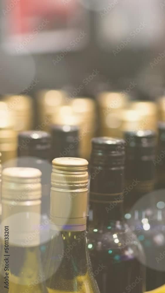 Poster animation of bokeh over wine bottles at shop