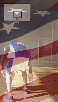 American flag waving against african american male basketball player practicing basketball