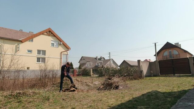 Man chopping tree roots slow motion in the village
