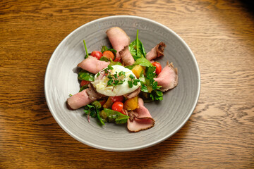 Grilled spicy lamb and salad wrapped in flatbread, with tomatoes