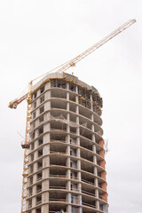 Construction of a high-rise building with a crane. Construction of buildings using formwork in Minsk