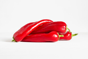 Red sweet peppers on a white background. Hot red pepper. Paprika