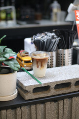Closeup of Iced Caramel Macchiato at the coffee shop, Caramel Macchiato is a classic macchiato beverage. It consists of vanilla syrup, espresso, steamed milk, foam, and caramel drizzle          