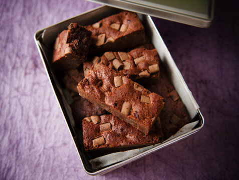 An Open Tin of Dark Chocolate Brownies with Chocolate Chunks.