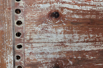 Old wooden door with holes. Wooden texture background