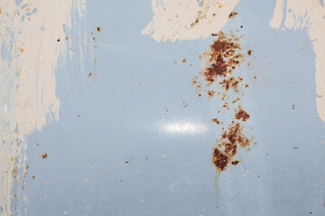 Texture of a blue surface with rust and strokes of white paint