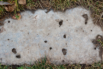 Old concrete slab in the ground. Texture of cement.