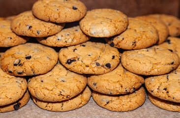 Homemade oatmeal cookies with fruit filling stacked on top of each other.