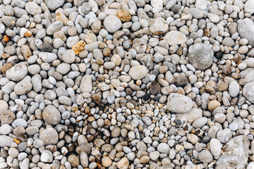 There are a lot of stones on the beach.