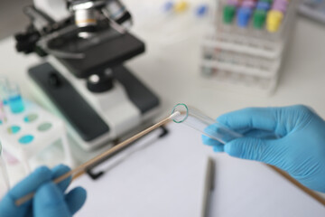 Doctor of laboratory diagnostics making DNA examination to determine paternity closeup