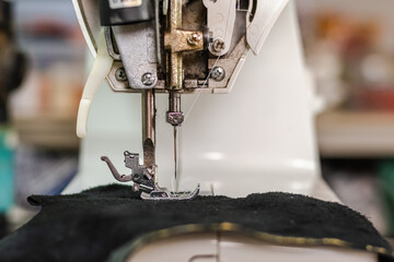 Close up sewing machine sew black genuine leather, Leather business