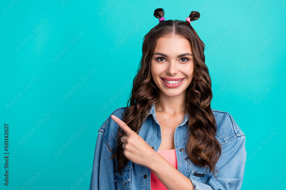 Sticker Photo of young cheerful girl indicate finger empty space recommend suggest banner isolated over turquoise color background