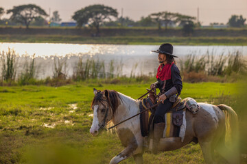 cowboy's way of life include riding a horse around locales. - obrazy, fototapety, plakaty