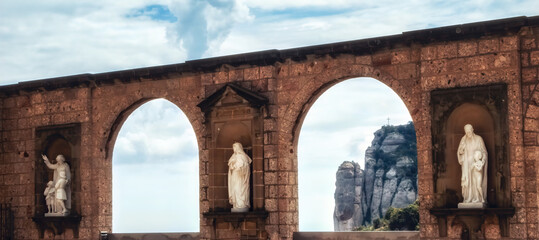 Statues on square in Montserrat monastery in Barcelona, Spain.