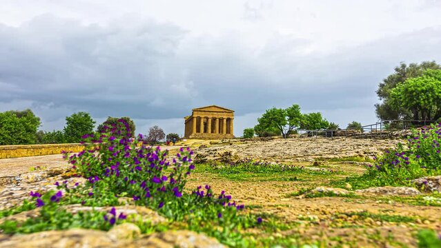 Time lapse shot tourist visiting ancient Valle Dei Templi during dark clouds at sky - Vacation trip on Sicily,Italy