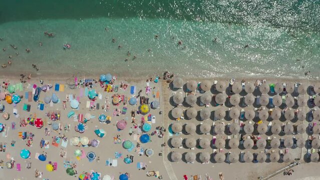Top view of People on the beach swim in the sea, aerial view