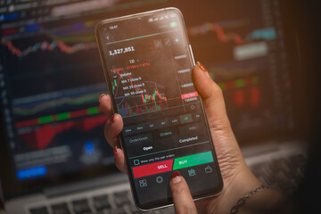 Women's hands are looking at data and making arbitrage trading on cryptocurrencies market on smart...