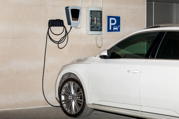 Electric Car charging in parking lot. EV Car or Electric car at charging station with the power cable supply plugged. Eco-friendly alternative energy concept