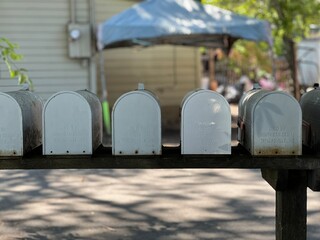 row of white mailboxes in a rural neighborhood