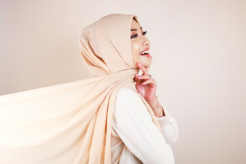 Muslim woman wearing traditional wear and hijab isolated on white background. Hijab is creatively...