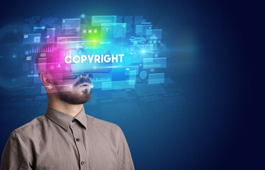 Businessman looking through Virtual Reality glasses