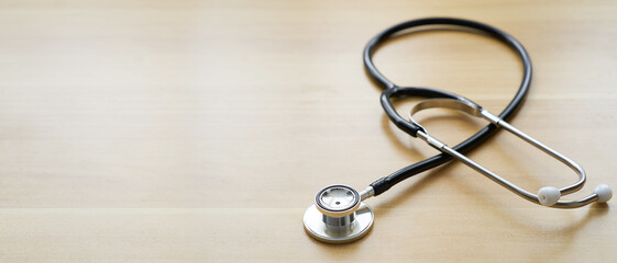 Stethoscope on wood table background, concept medical instrument with copy space                         