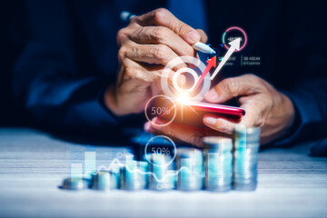 Businessman using smart phone mobile with business graph and stacking coins