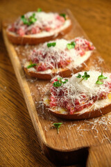 Beef tartar with salad and garlic toast on dark bread