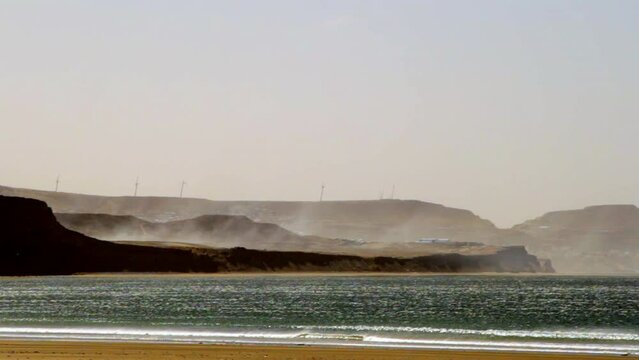 static shoot of the mountains of Rada Tilly Patagonia Argentina where we see the mountains open the way to the city with the beach in the background during a sunny winter day