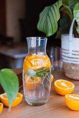 Orange infused water with peppermint, summer drink.