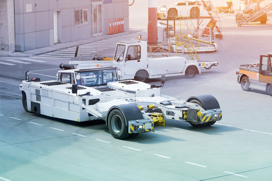 Tow Truck Vehicles With The Mechanism For Lifting The Nose Landing Gear Of The Aircraft Trailer For Puch Back Plane At The Airfield.