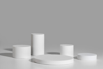 Podium mockup with five cylinders on gray background