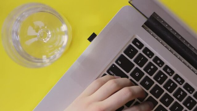 Co working space typing blogging on a yellow backdrop