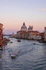 Grand channel in Venice, followed by the ships, sunset and Basilica della Salute