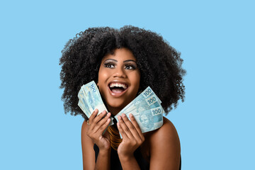  woman smiling holding brazilian money bills, positively surprised, space for text, person, advertising concept	