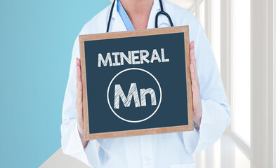 Mineral Mn- Doctor shows information on blackboard.Doctor holding chalkboard with text.