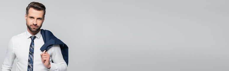 businessman in white shirt holding blue blazer isolated on grey, banner.