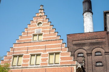 MECHELEN, Malines, Antwerp, BELGIUM, March 2, 2022, Old facades, roofs and chimney of the beer...