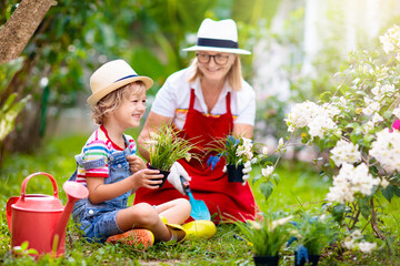 Woman and child gardening. Grandmother and kid.