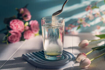 matcha Collagen powder is add to glass of water with a spoon. Healthy and anti-age concept