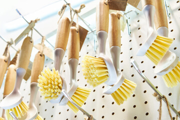 Household brushes with wooden handles in store