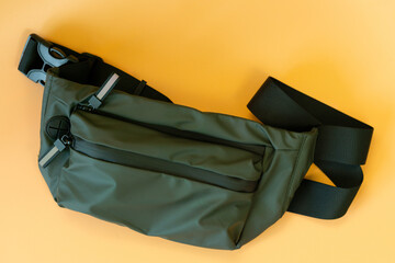 Waterproof khaki waist bag on an yellow background. Orange. Clothing. 100 Dollars. Private....