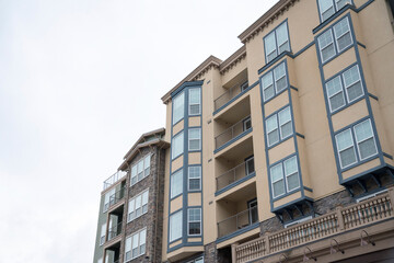 Low-angle view of a mid-rise apartment building with balconies and windows