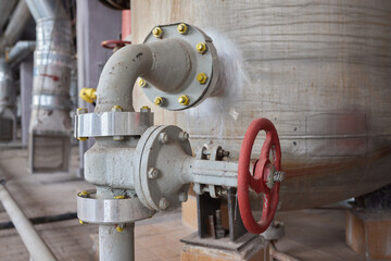 Close-up at pipeline valve which is using to control production process in the oil refinery plant....